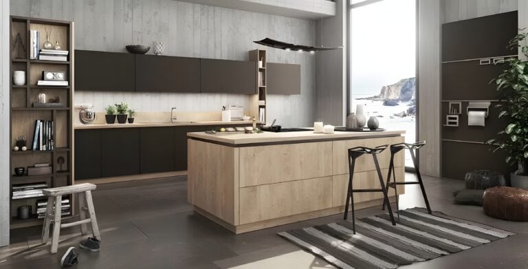 Modern kitchen with light wood Bauformat cabinets and countertops, a large island with stools, open shelving, plants, and a rug. Floor-to-ceiling window with a beach view. Minimalist decor with neutral tones. Quality craftsmanship from Germany ensures both style and durability.