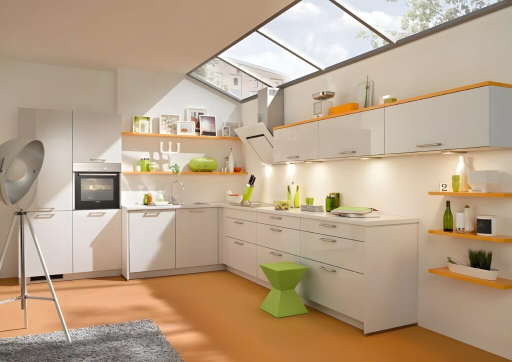 Modern kitchen with white cabinets, green accents, built-in oven, sink, and various kitchen items on shelves. Skylight and large windows provide natural light. Orange floor contrasts with white decor, showcasing the latest kitchen design trends for home cooks.