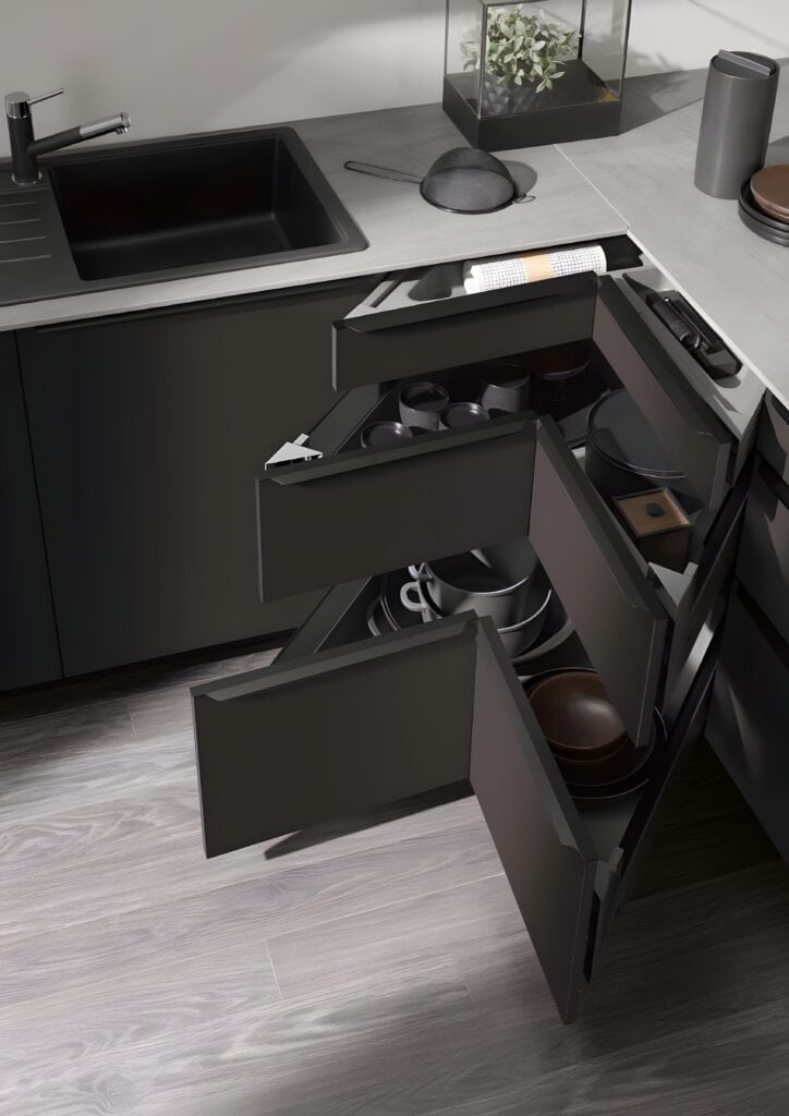 A modern kitchen with black cabinets and drawers open, revealing neatly organized kitchenware and utensils, features space-saving kitchen furniture for maximum efficiency.
