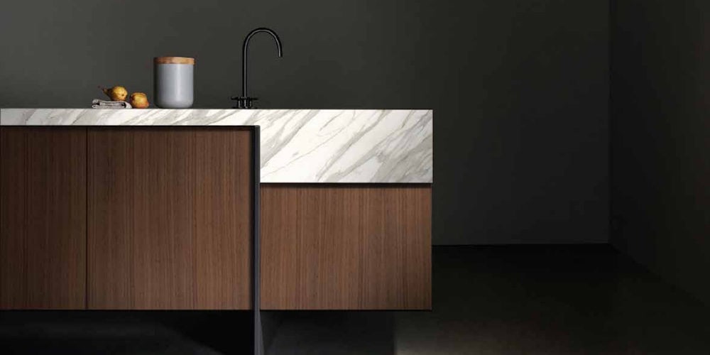 Baulux walnut island with Calacatta marble waterfall counter by Bauformat