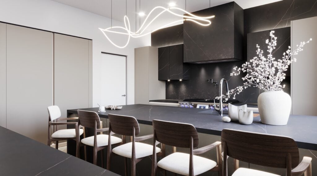 Modern kitchen with black countertops, wooden chairs lined along an island, minimalist cabinetry featuring the latest cabinet tech upgrades, a sleek overhead light fixture, and a large white vase with branches.