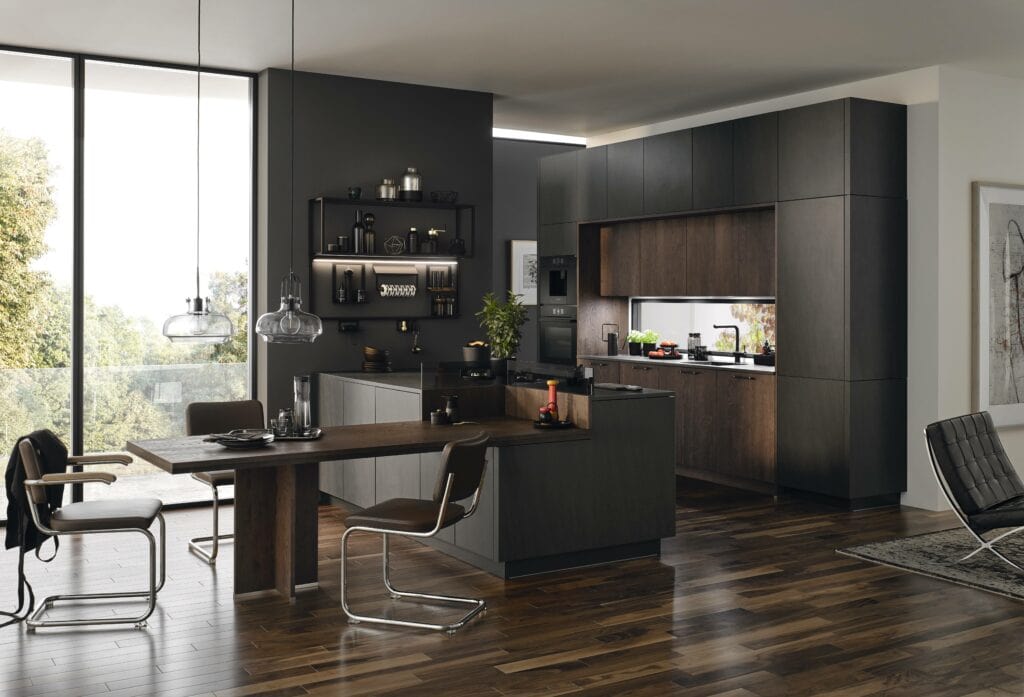 Modern kitchen with dark cabinetry, built-in appliances, space-saving kitchen furniture, a dining table with chairs, open shelves, and large windows allowing natural light. The decor features dark wood flooring and a minimalist design.