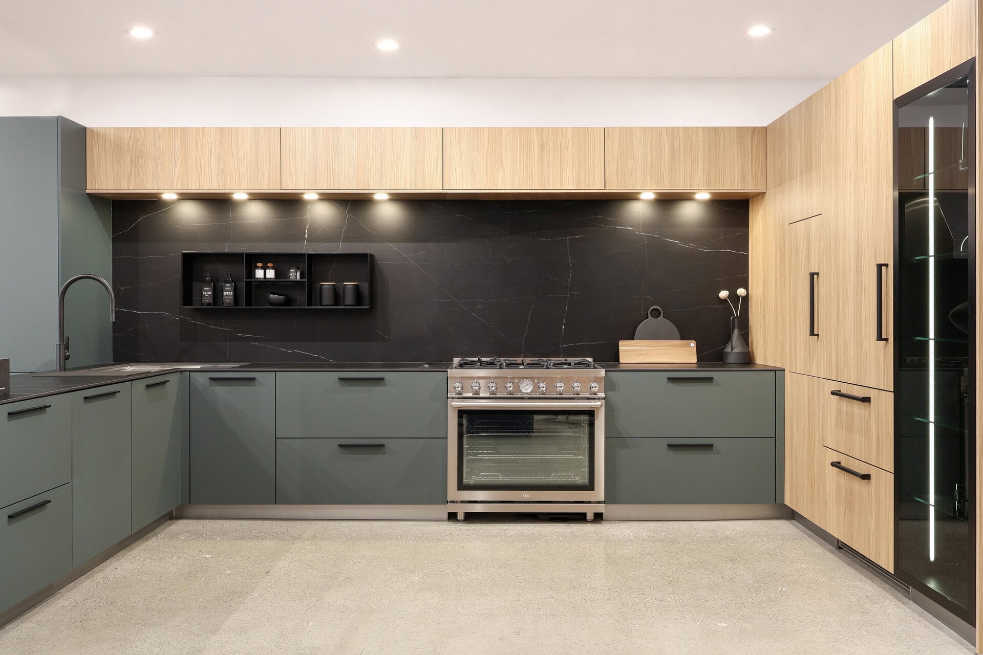 Bauformat kitchen display — warm oak melamine, matt lacquer