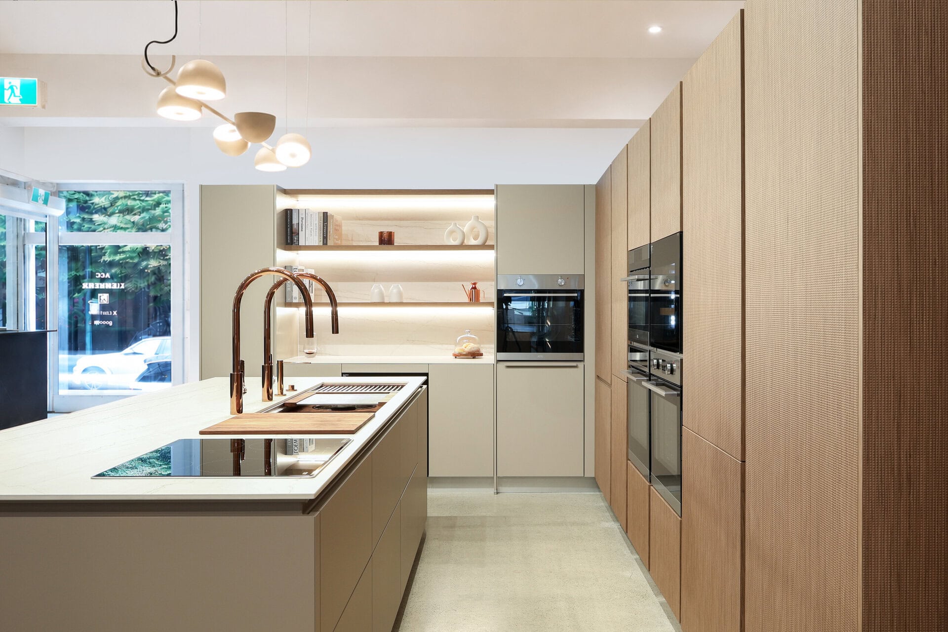 Bauformat kitchen display — textured walnut, warm taupe, rose gold