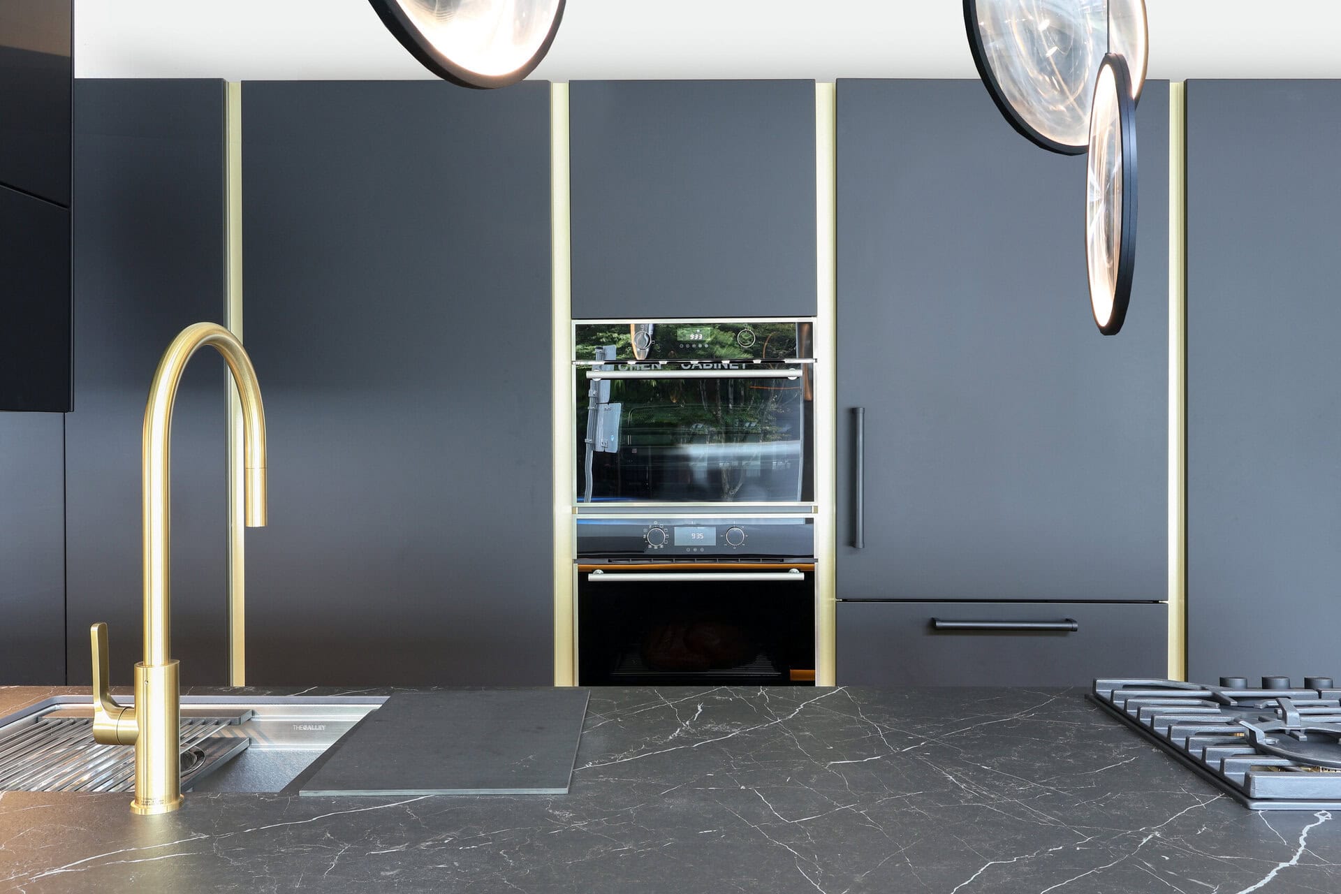 Bauformat kitchen display — slate black with brass reveal