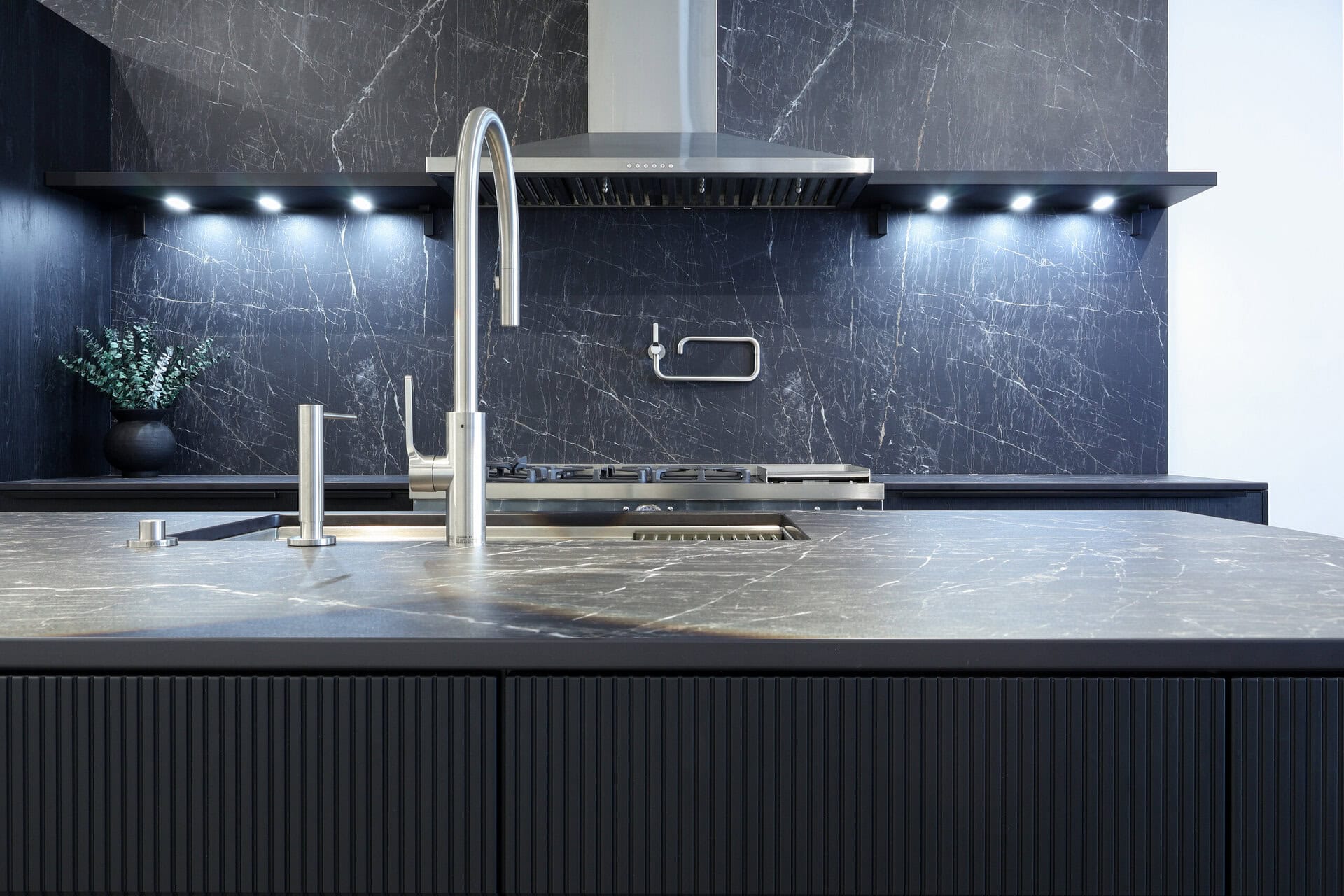 Bauformat kitchen display — fluted base cabinetry detail