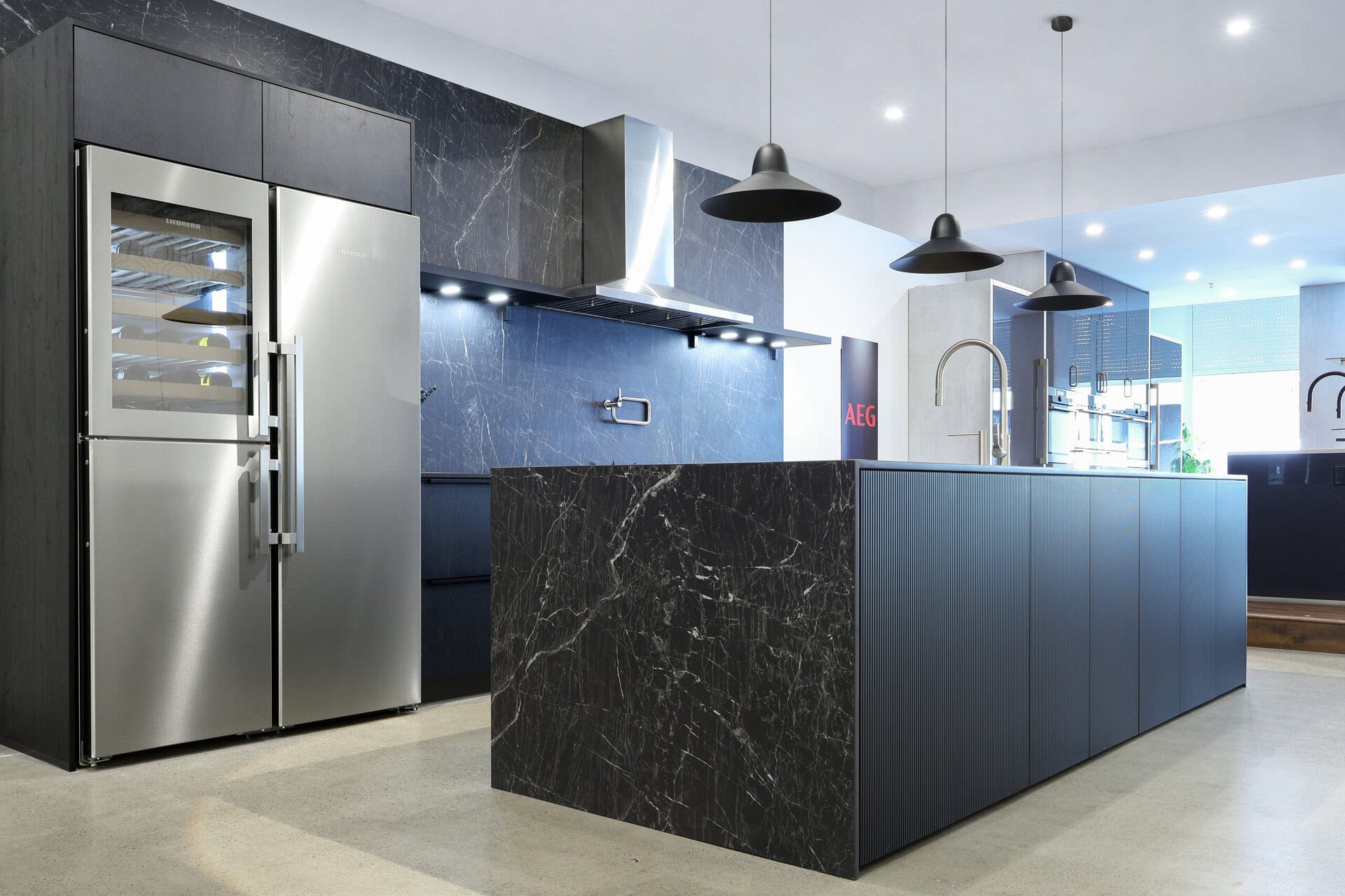 Bauformat kitchen display — fluted island beside integrated storage