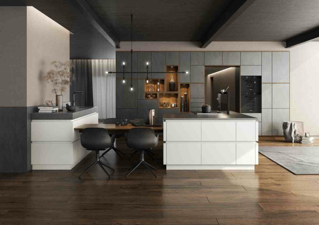 A modern kitchen with dark wooden floors, light grey cabinetry, a large island with two black chairs, pendant lights, and an open shelving unit displaying various items—perfect kitchen design ideas for home cooks.